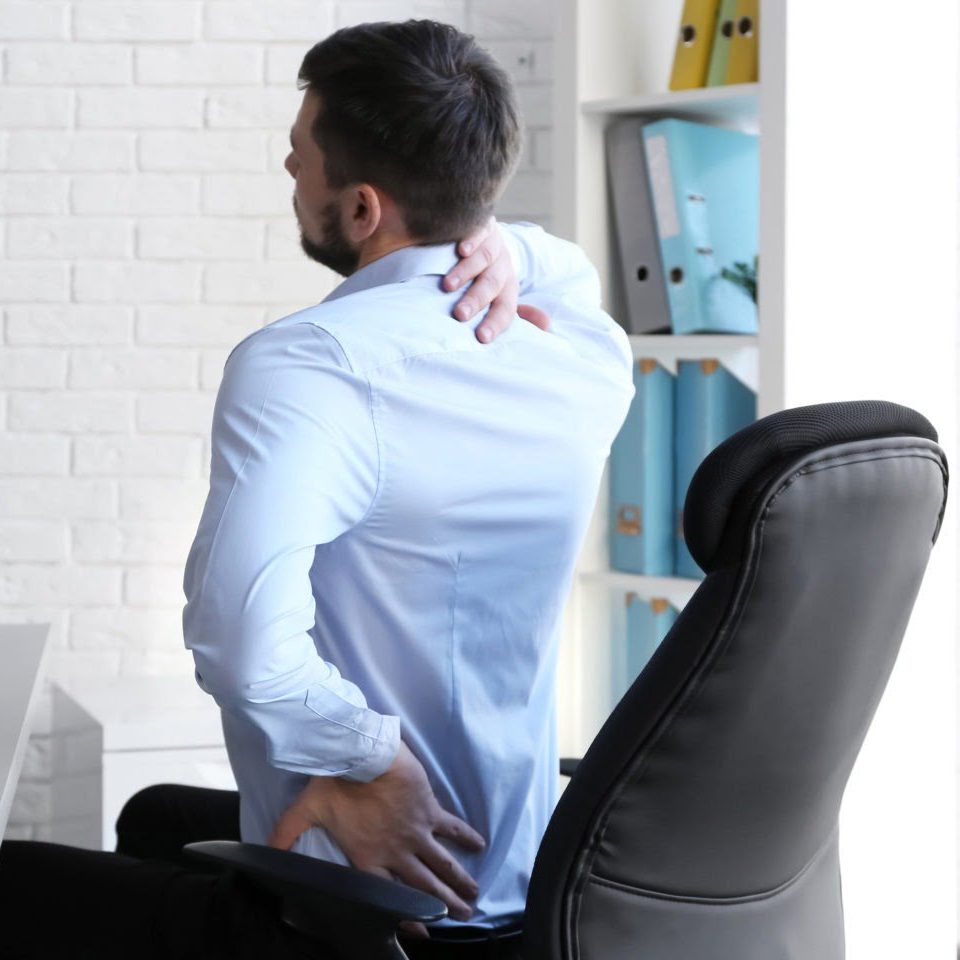 health risks of sitting too long at a desk all day include lower back, neck and hip pain