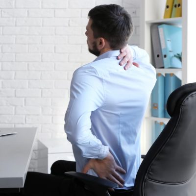 health risks of sitting too long at a desk all day include lower back, neck and hip pain